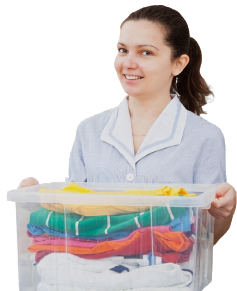 A smiling professional laundry attendant holding a clear bin of neatly folded, colorful clothes.